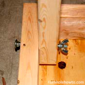 Attaching the legs to the table with the bolt, washers, and wing nut.