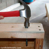 Hammering the carriage bolt into place.