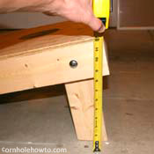 Checking the height of the cornhole table.