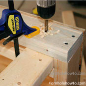 Drilling the hole through the table frame.