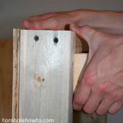 Marking the cornhole table frame for the legs.