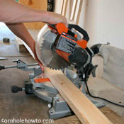 Cutting wood with a mitre saw.